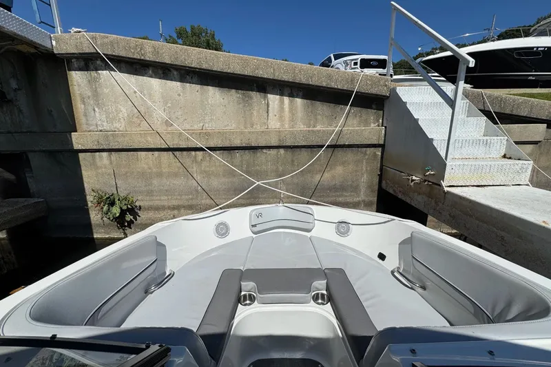 Slide: The Image of 2022 Bayliner VR6 Bowrider OB docked, showcasing spacious seating and sleek design. - 19