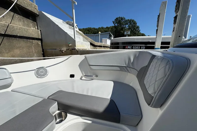 Slide: The Image of 2022 Bayliner VR6 Bowrider OB interior with gray seating and cup holder. - 20