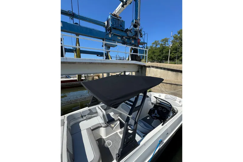 Slide: The Image of 2022 Bayliner VR6 Bowrider OB in a boat lift, featuring sleek design and modern controls. - 25