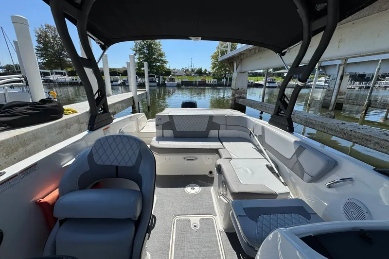 Slide: The Image of 2022 Bayliner VR6 Bowrider OB interior with seating, docked at marina. - 3