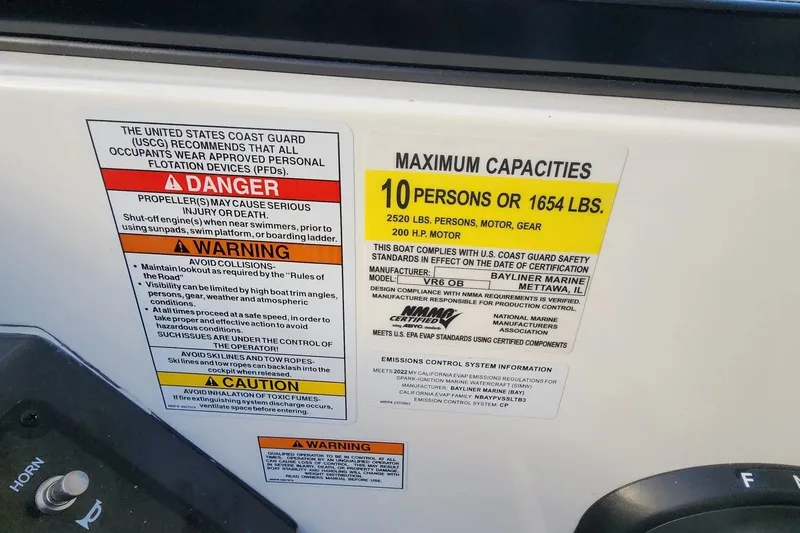 Slide: The Image of 2022 Bayliner VR6 Bowrider OB capacity label, 10 persons or 1654 lbs, safety warnings included. - 32