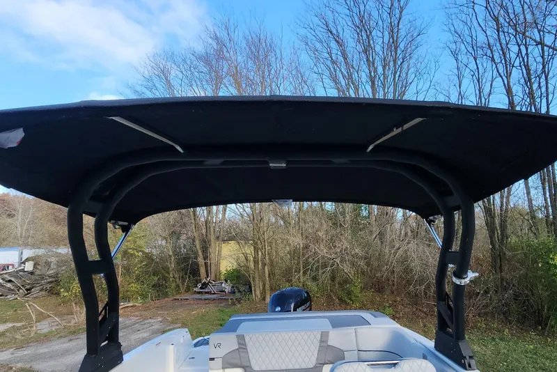 Slide: The Image of 2022 Bayliner VR6 Bowrider OB with black canopy, parked outdoors. - 33