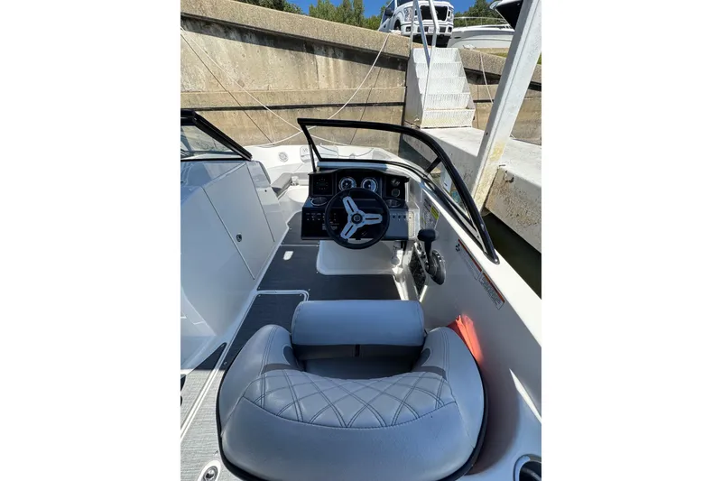 Slide: The Image of 2022 Bayliner VR6 Bowrider OB cockpit with steering wheel and seating. - 4