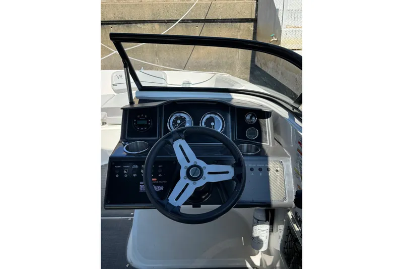 Slide: The Image of 2022 Bayliner VR6 Bowrider OB dashboard with steering wheel and gauges. - 5