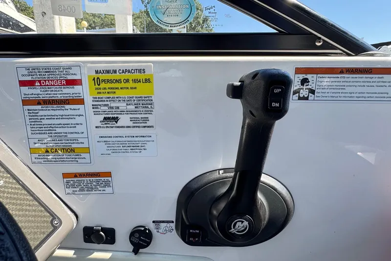 Slide: The Image of 2022 Bayliner VR6 Bowrider OB control panel with capacity warnings and throttle lever. - 6