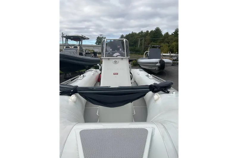 Slide: The Image of 2011 Sealegs 7.1 inflatable boat with console, parked outdoors under cloudy sky. - 11