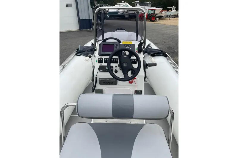 Slide: The Image of Interior view of 2011 Sealegs 7.1 boat, featuring steering wheel and control panel. - 5