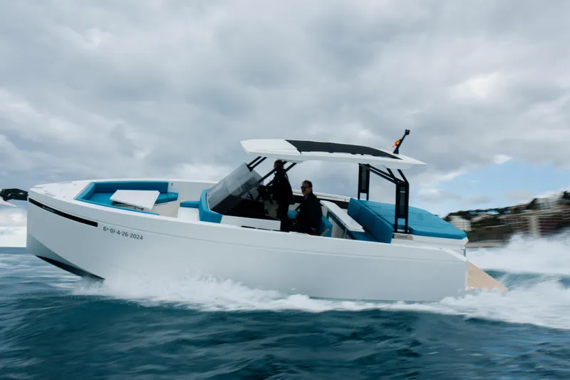 Slide: The Image of 2026 De Antonio Yachts D29 cruising on open water, creating dynamic waves. - 2