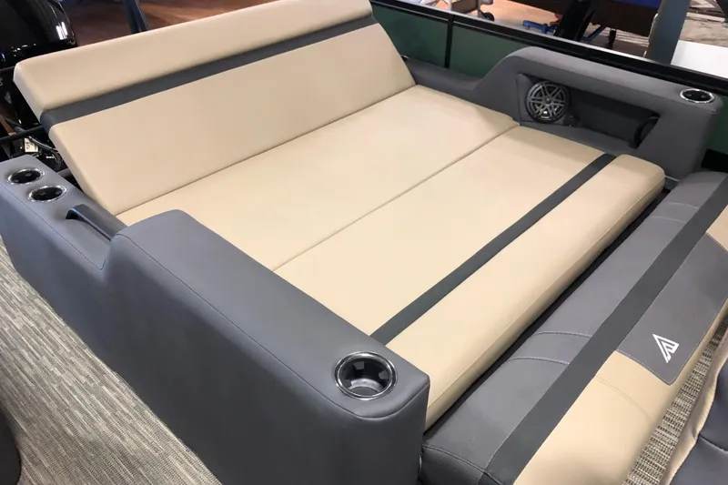 Slide: The Image of 2026 Viaggio X22S boat interior with beige and gray seating, cup holders, and speaker. - 10