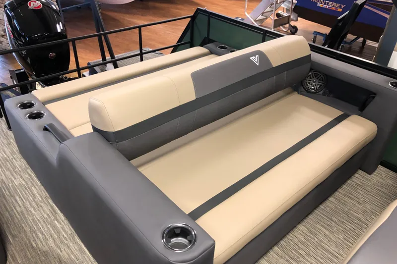 Slide: The Image of 2026 Viaggio X22S boat interior with beige and gray seating, cup holders, and speaker. - 6