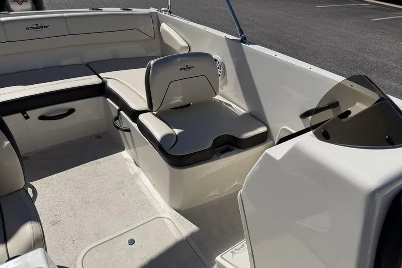 Slide: The Image of 2023 Stingray 172SC boat interior with beige seating and black accents. - 10