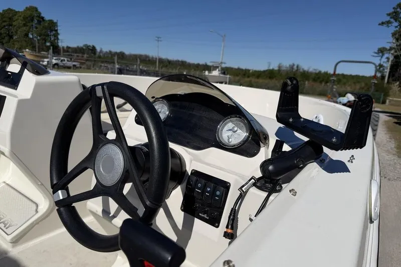 Slide: The Image of 2023 Stingray 172SC boat dashboard with steering wheel and controls. - 12