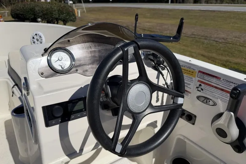 Slide: The Image of 2023 Stingray 172SC boat dashboard with steering wheel and control panel. - 15