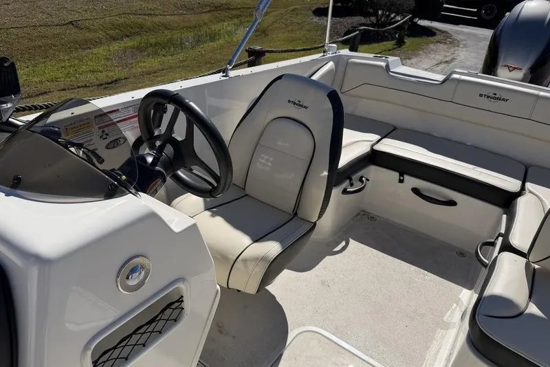 Slide: The Image of 2023 Stingray 172SC boat interior with steering wheel and seating area. - 17