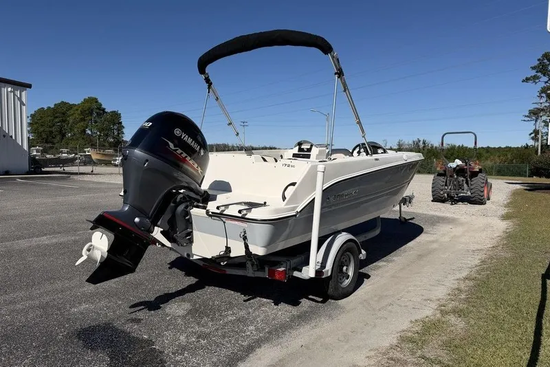 Slide: The Image of 2023 Stingray 172SC boat with Yamaha outboard motor on a trailer, parked outdoors. - 5