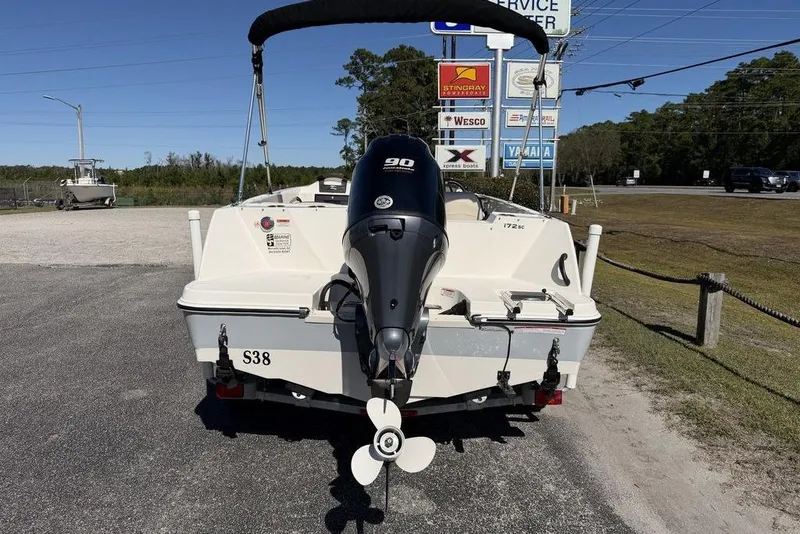Slide: The Image of 2023 Stingray 172SC boat with 90HP engine, parked near service center. - 8
