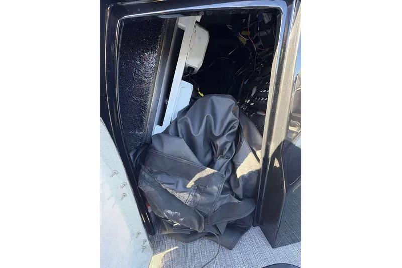 Slide: The Image of Open compartment of 2025 Viaggio D26U with visible wiring and black fabric. - 16