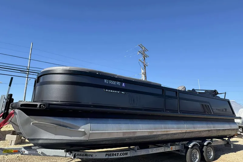 Slide: The Image of 2025 Viaggio D26U pontoon boat on trailer under clear blue sky. - 2