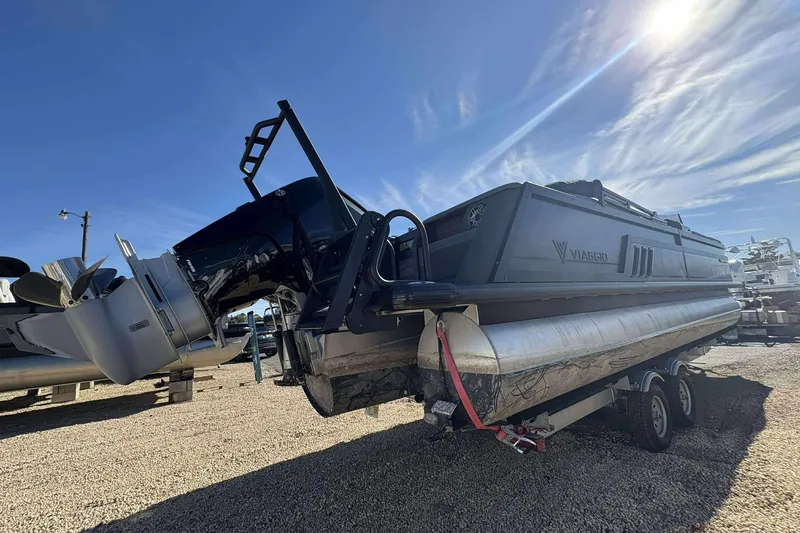 Slide: The Image of 2025 Viaggio D26U pontoon boat on trailer under clear blue sky. - 26
