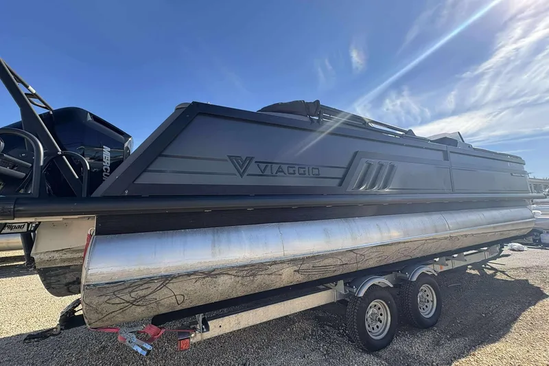 Slide: The Image of 2025 Viaggio D26U pontoon boat on trailer under clear blue sky. - 30