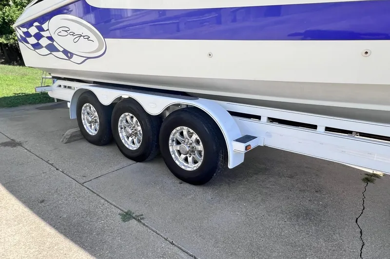 Slide: The Image of 1996 Baja .38 Special boat logo with blue script on white background. - 108