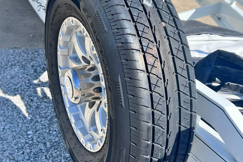 Slide: The Image of 1996 Baja .38 Special boat on trailer, covered, near a lake. - 109