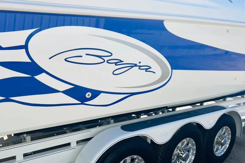Slide: The Image of 1996 Baja .38 Special boat with blue and white design on trailer. - 11
