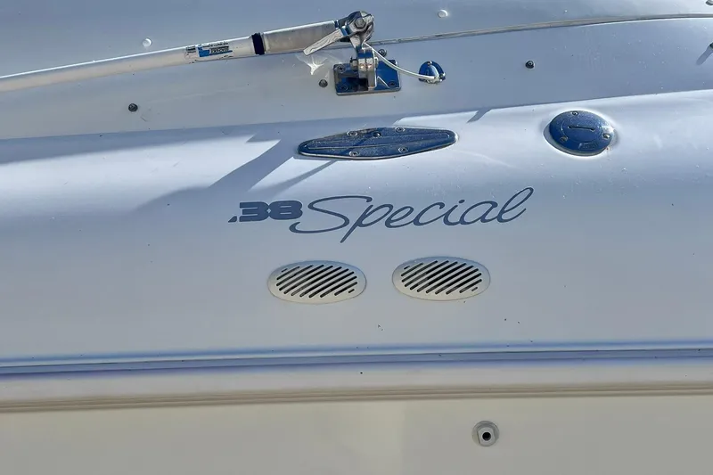 Slide: The Image of 1996 Baja .38 Special boat on trailer, covered, parked outdoors. - 110