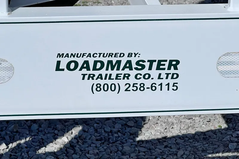 Slide: The Image of 1996 Baja .38 Special boat on a triple-axle trailer with chrome wheels. - 111