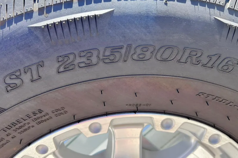 Slide: The Image of Close-up of a tire with "ST 235/80R16" marking, Baja .38 Special 1996 model. - 117