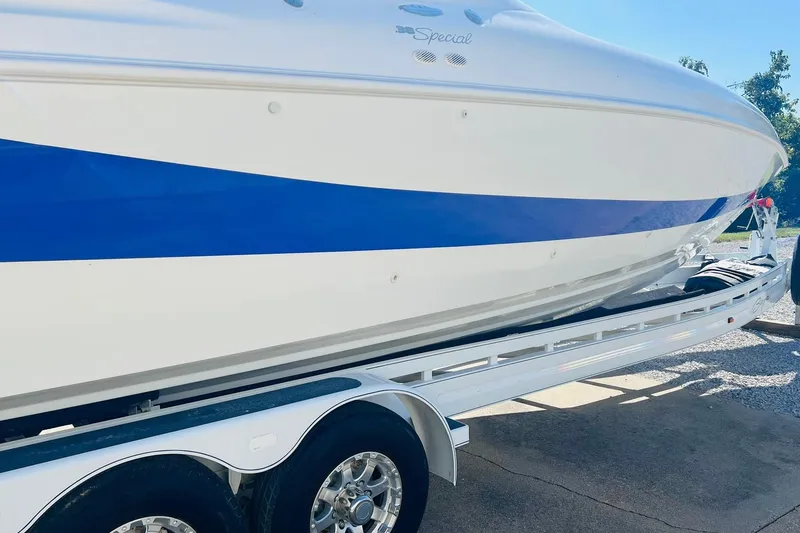 Slide: The Image of 1996 Baja .38 Special boat on trailer, featuring sleek blue and white design. - 13