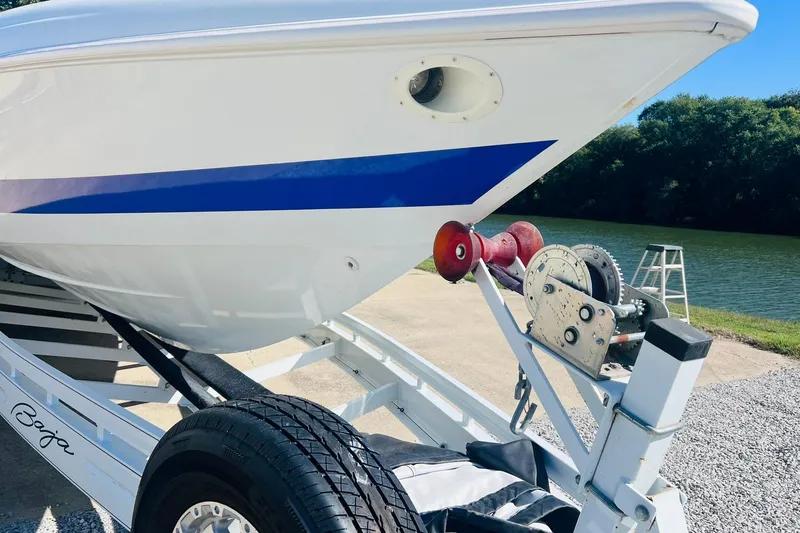 Slide: The Image of 1996 Baja .38 Special boat on trailer by a riverbank. - 14