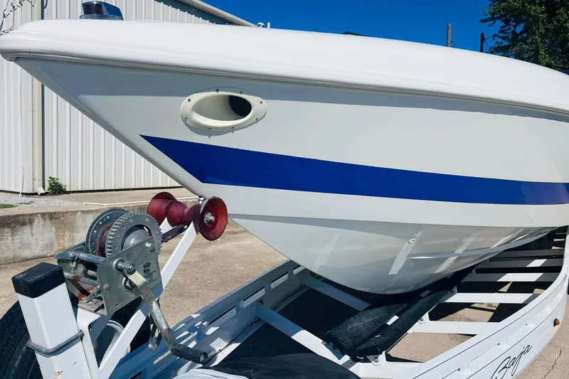 Slide: The Image of 1996 Baja .38 Special boat on trailer, featuring sleek white hull with blue stripe. - 15