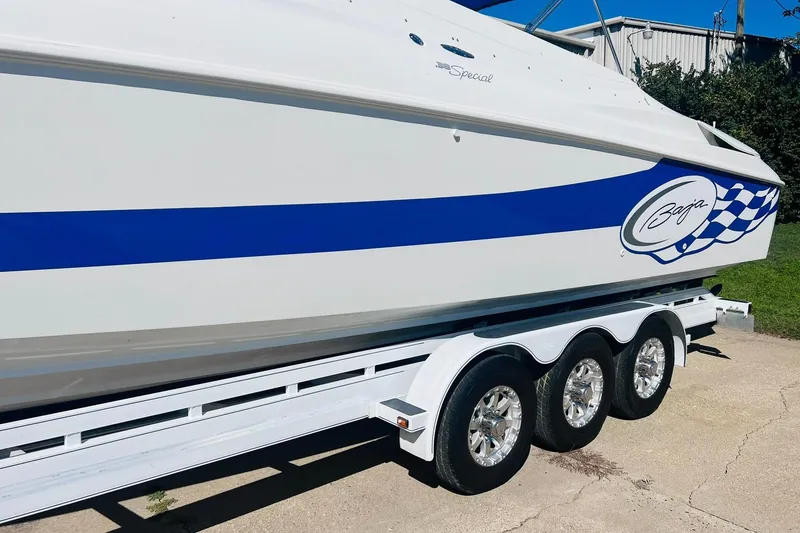 Slide: The Image of 1996 Baja .38 Special boat on trailer with blue stripe and logo. - 18