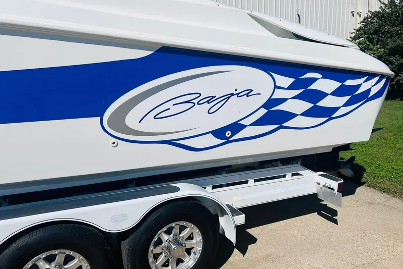 Slide: The Image of 1996 Baja .38 Special boat with blue racing stripe design on trailer. - 19