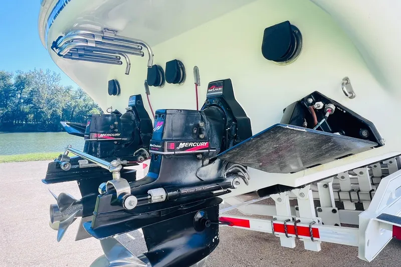 Slide: The Image of 1996 Baja .38 Special boat with dual Mercury outboard engines, docked by a serene river. - 21