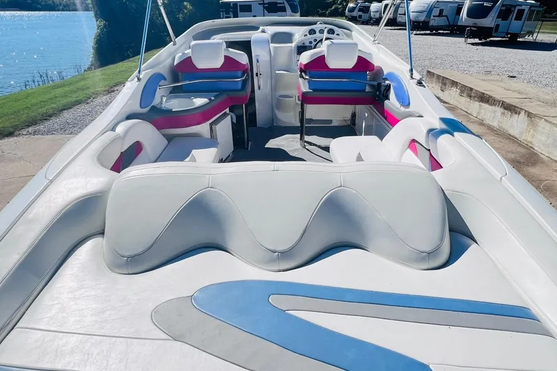 Slide: The Image of 1996 Baja .38 Special boat with white and pink interior, docked near a lake. - 27
