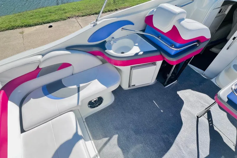 Slide: The Image of 1996 Baja .38 Special boat interior with pink and white seating, sink, and storage. - 29