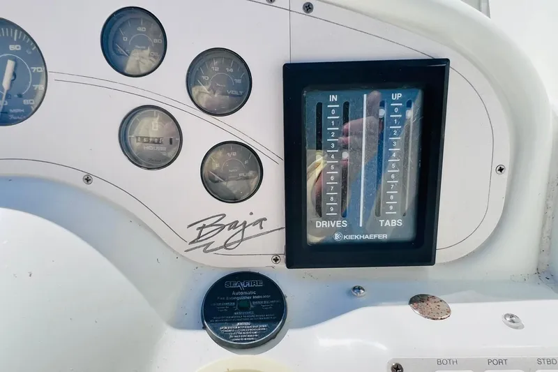 Slide: The Image of Dashboard of a 1996 Baja .38 Special boat with gauges and controls. - 40
