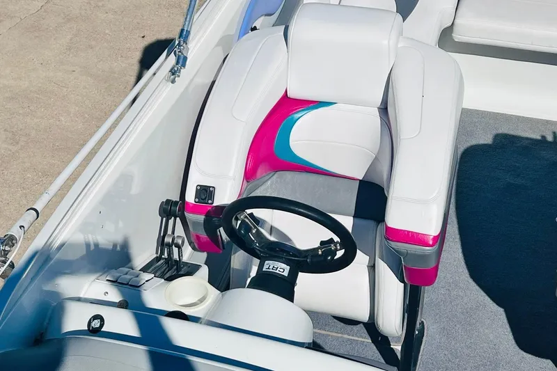 Slide: The Image of 1996 Baja .38 Special boat cockpit with vibrant white, pink, and blue seating. - 42