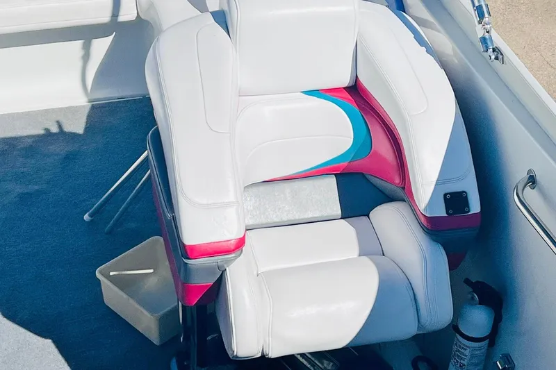 Slide: The Image of 1996 Baja .38 Special boat interior with white and pink seating, fire extinguisher, and storage box. - 45
