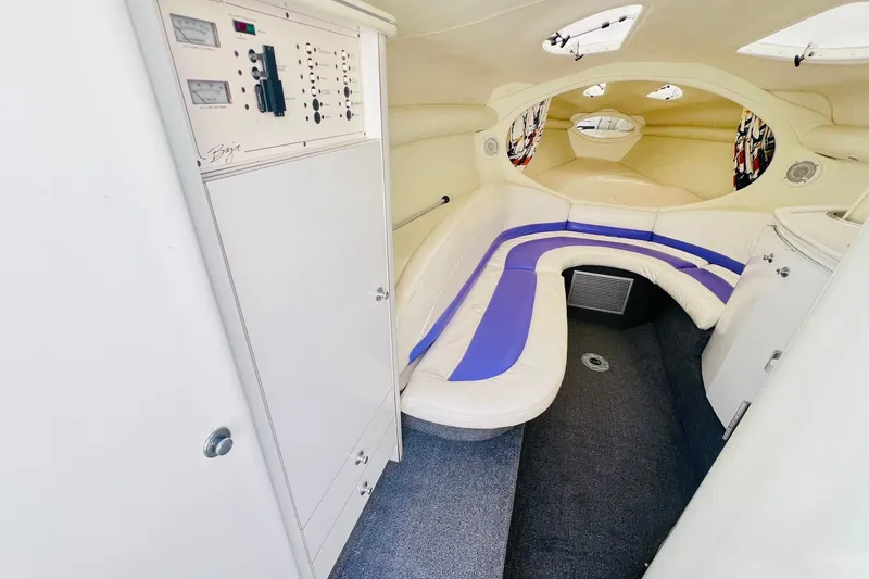 Slide: The Image of 1996 Baja .38 Special boat interior with white and purple seating, control panel, and carpeted floor. - 49
