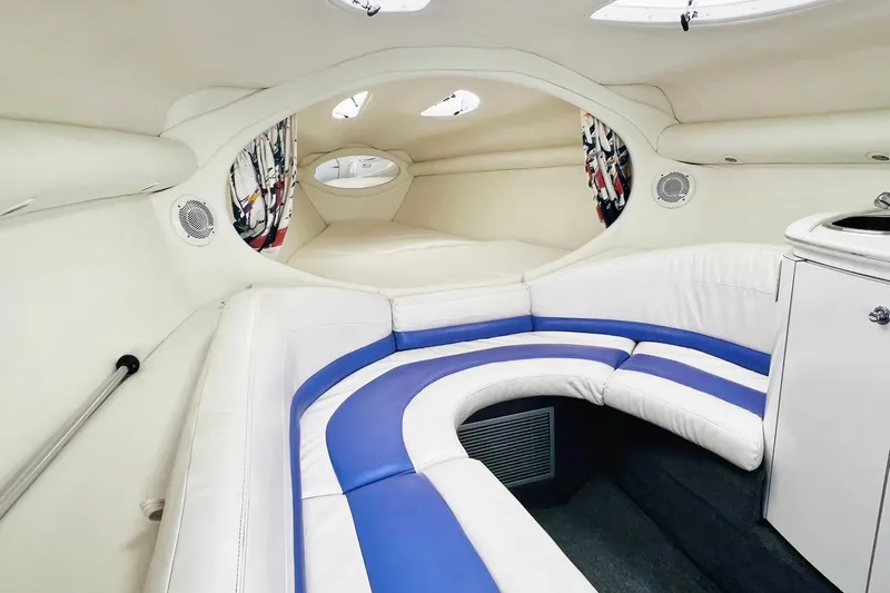 Slide: The Image of Interior of a 1996 Baja .38 Special boat with white and blue seating. - 50