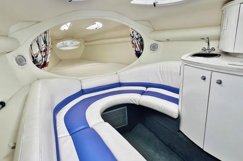 Slide: The Image of Interior of a 1996 Baja .38 Special boat with white and blue seating, compact kitchenette. - 51