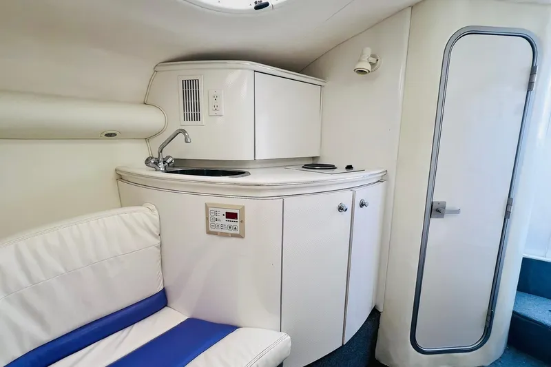 Slide: The Image of Interior of a 1996 Baja .38 Special boat with kitchenette and seating area. - 53