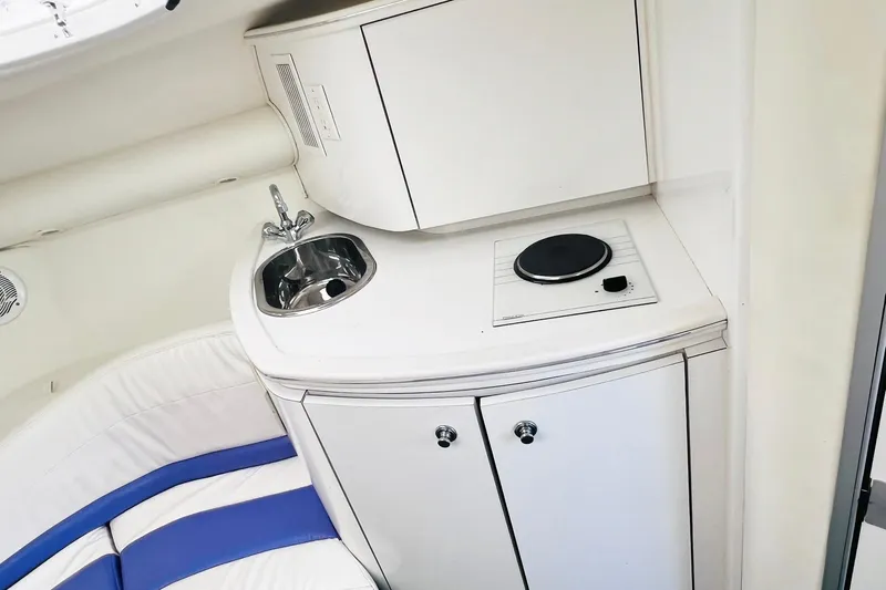 Slide: The Image of Compact kitchenette in 1996 Baja .38 Special boat with sink and stove. - 55