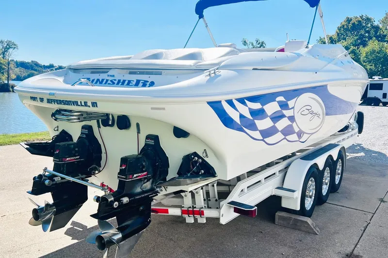Slide: The Image of 1996 Baja .38 Special speedboat on trailer, featuring dual Mercury engines and checkered flag design. - 6