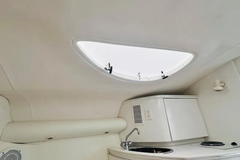 Slide: The Image of Interior of a 1996 Baja .38 Special boat with white and blue seating. - 60