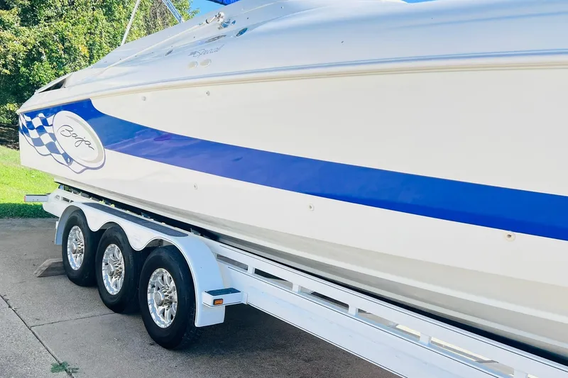 Slide: The Image of 1996 Baja .38 Special boat on trailer with blue stripe and logo. - 7