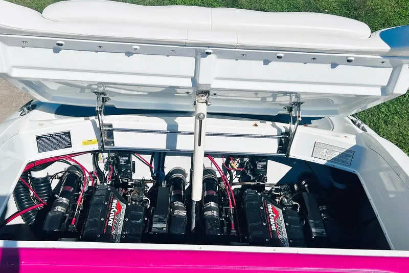 Slide: The Image of Open engine compartment of a 1996 Baja .38 Special boat, showcasing dual engines. - 71